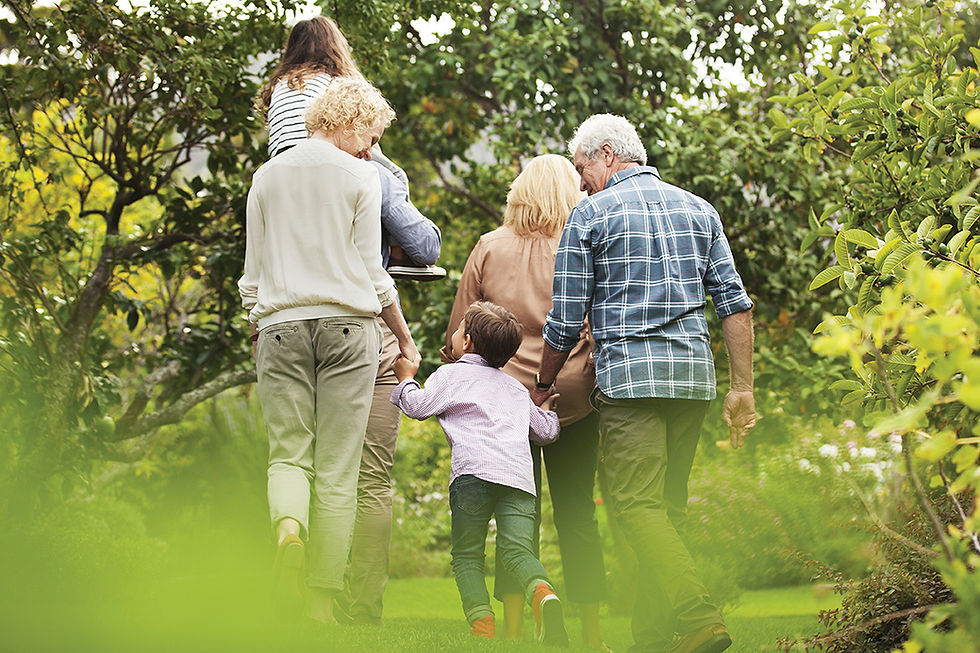 Multi-generational family walking together in a garden