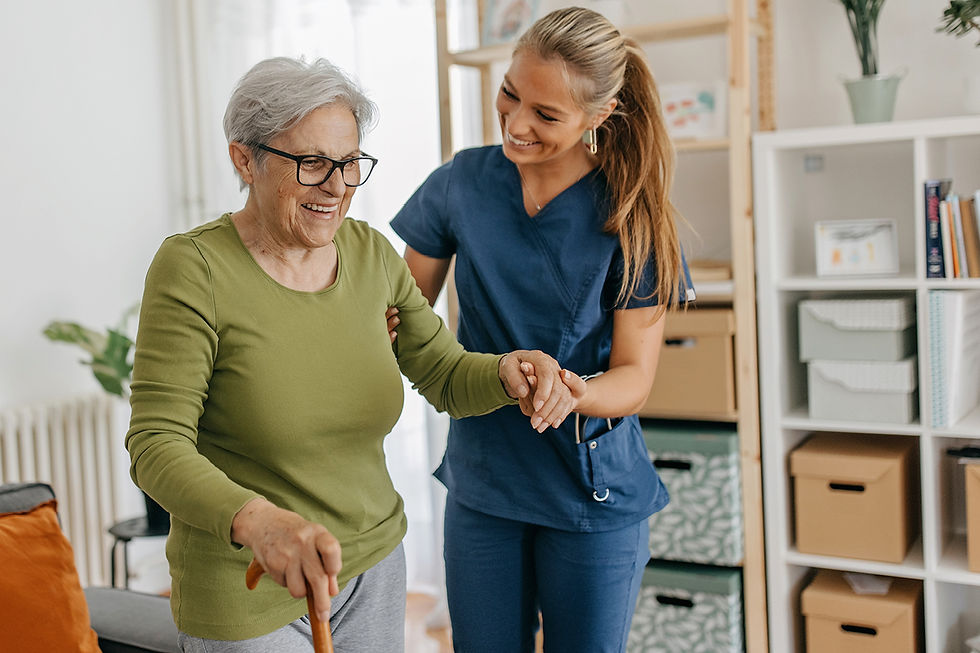Caregiver assisting an elderly woman with a cane