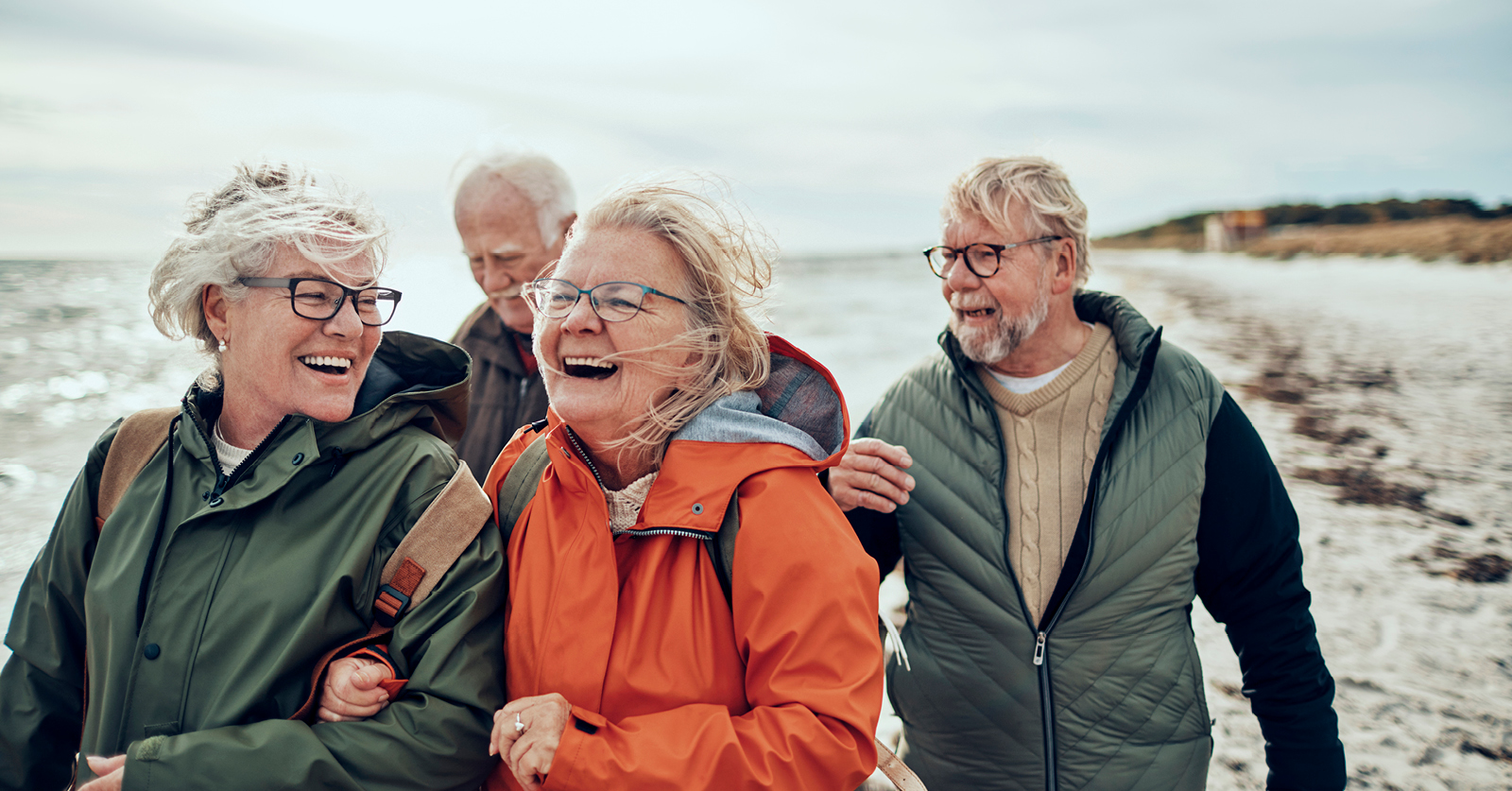 Senior adults walking on beach